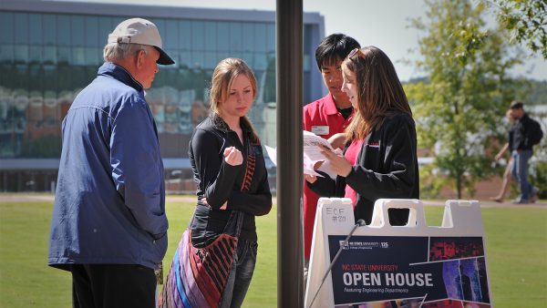 A prospective student and her father get directions around the engineering buildings on Centennial Campus during Open House.