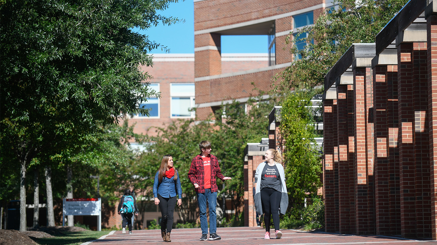 Students walk by Engineering buildings on the oval on Centennial campus. Photo by Marc Hall